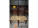 8 brown wooden chairs with wicker seat